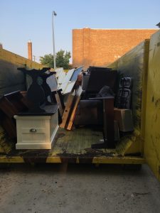 the inside of a dumpster filled with furniture that had been exposed to toxic mold