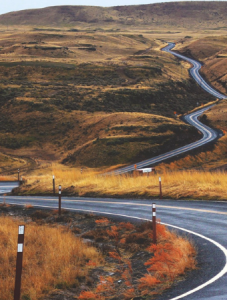 hillside with winding road to symbolize the winding pattern of healing