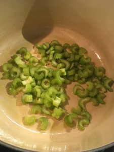 celery and garlic in dutch oven before sautéing