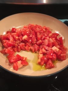 fresh tomatoes chopped in pan with olive oil