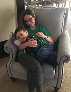 mother and son cuddling on living room chair after mother's release from hospital stay
