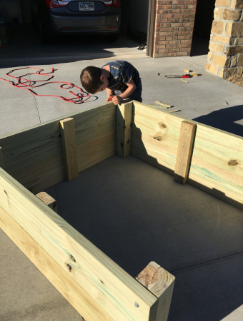 Boy assembling garden box